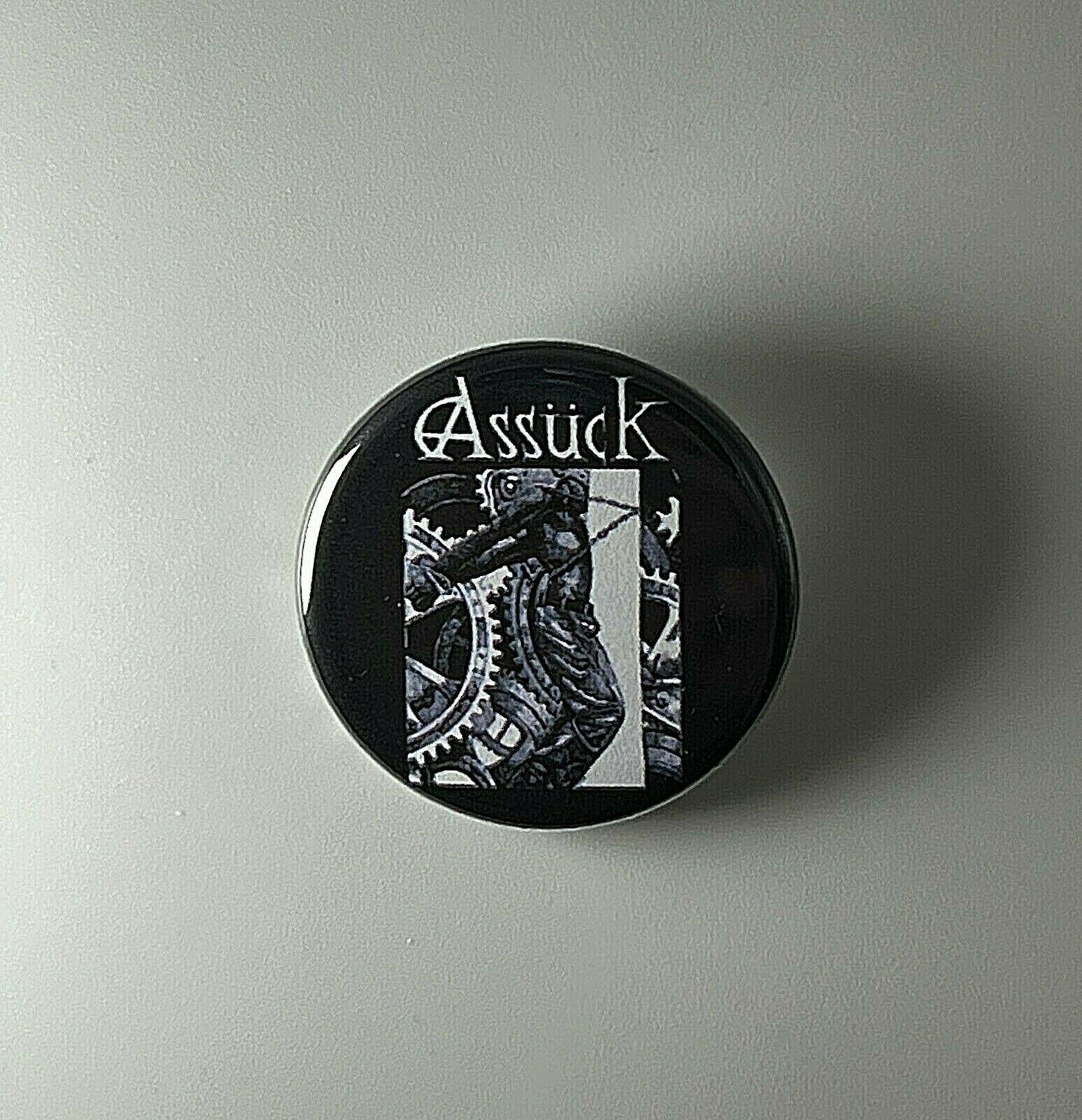 Assuck Anticapital 1.25" Button A013B125